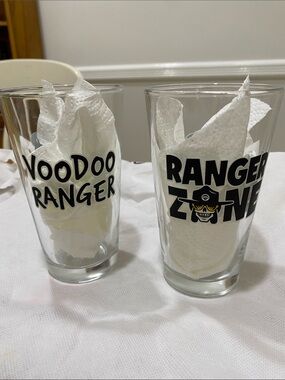 NWOT.  Set of 2, “Voodoo Ranger”, clear with black graphics, pint glasses.
